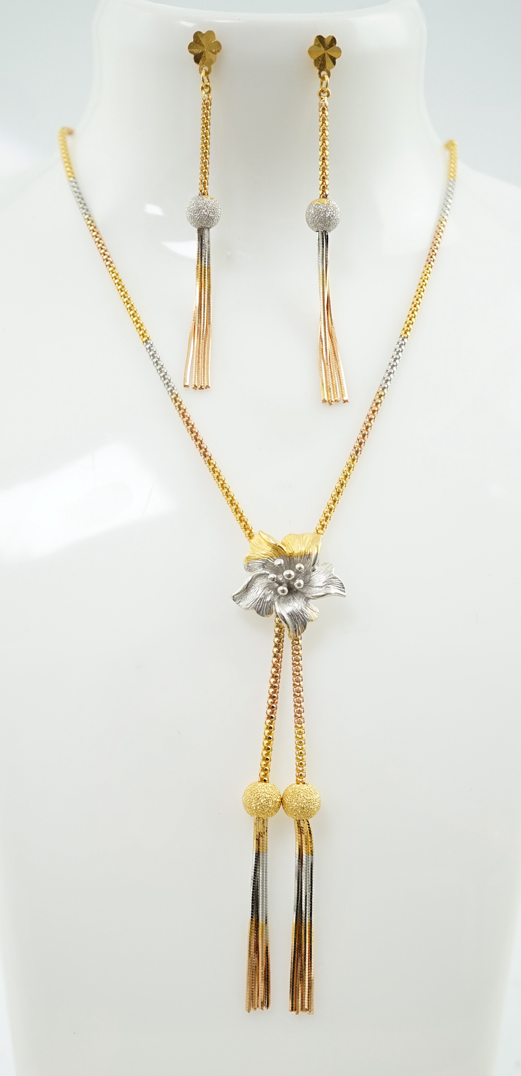 A recent Middle Eastern three colour 22k gold tassel drop necklace and pair of matching drop earrings